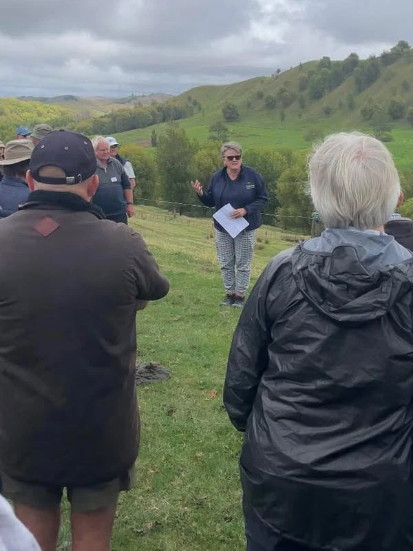 Marie Taylor Founder of Plant Hawke's Bay giving a talk to an audience outside in a field